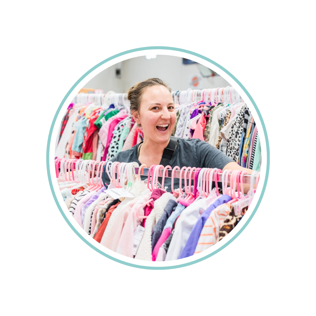 Mom holds hand up to show of rows and rows of clothing for sale at 50 to 90% off retail prices!